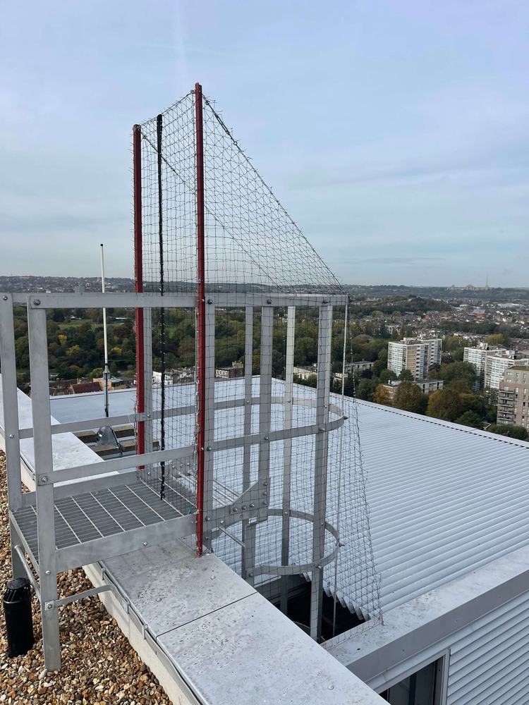 Tall netting frame on a commercial rooftop