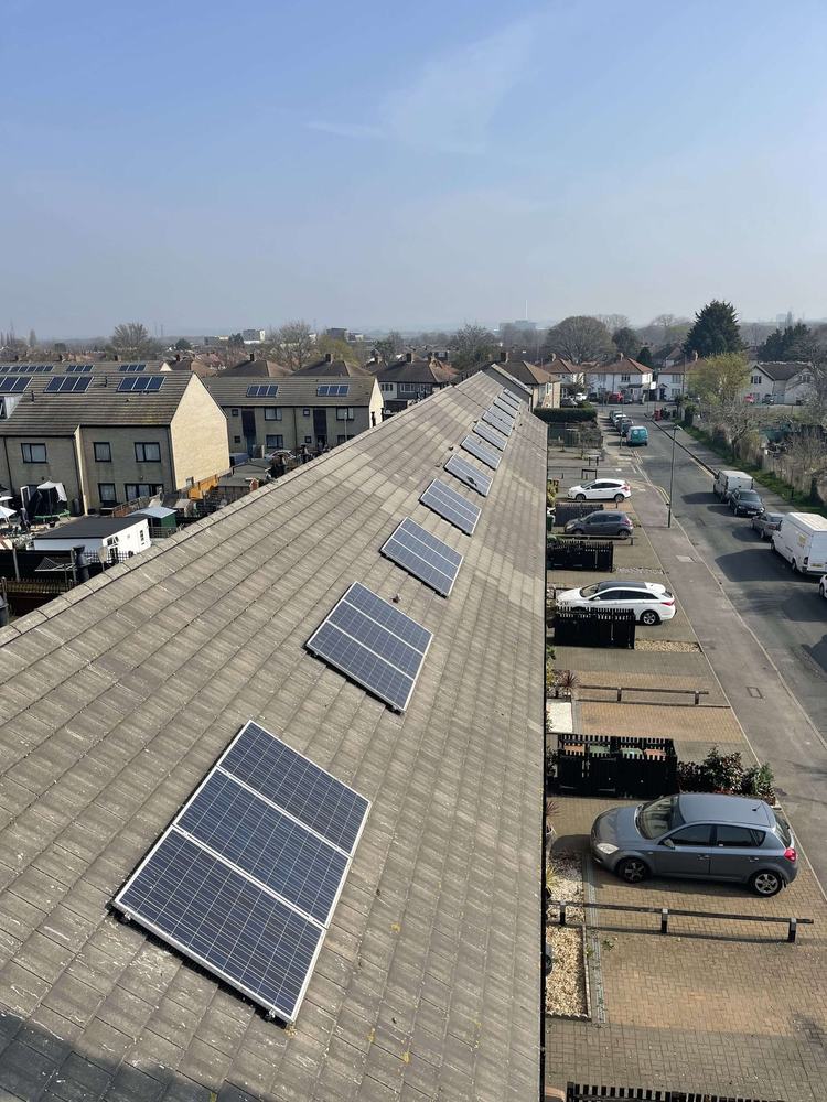 A row of solar panels on a long pitched roof