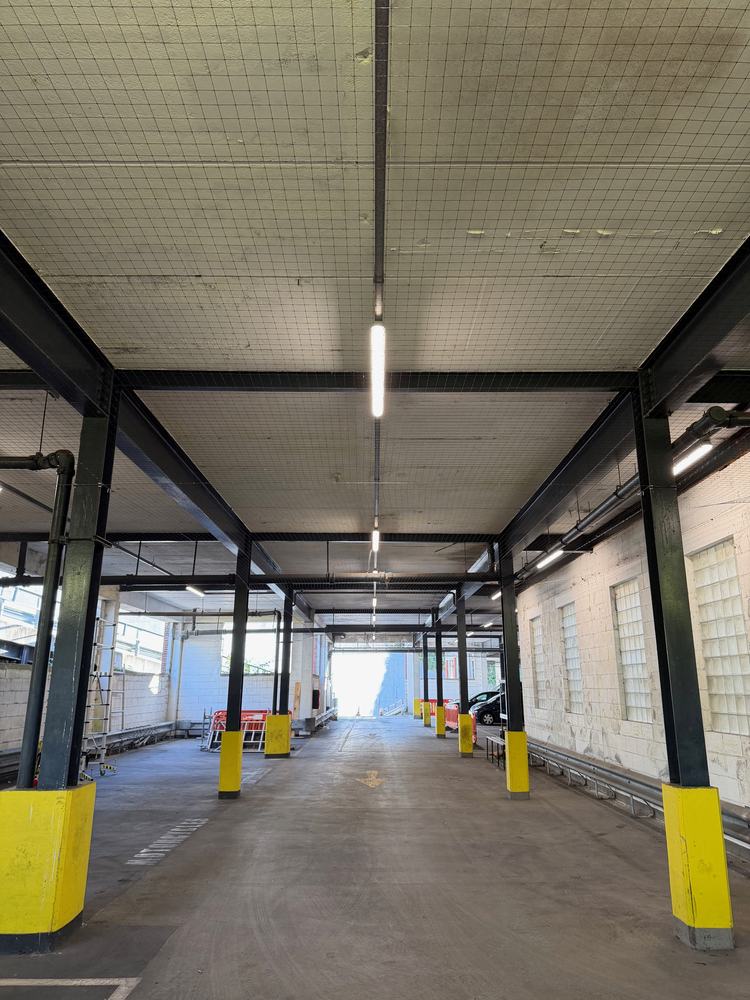Bird netting fitted under the ceiling of a multi-storey car park
